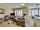 Spacious living room featuring neutral tones, plantation shutters, and wood-look floors, creating a warm atmosphere at 435 Piute Valley Ct, Henderson, NV 89012