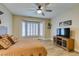 Well-lit main bedroom with neutral walls, plantation shutters, and a ceiling fan at 435 Piute Valley Ct, Henderson, NV 89012