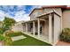 Beautiful backyard with covered patio, easy-care artificial turf, and desert landscaping at 4411 Wild Honey Ct, Las Vegas, NV 89147