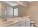 Bathroom with a dual sink vanity, a large mirror, and a glass-enclosed shower at 4411 Wild Honey Ct, Las Vegas, NV 89147