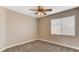 Neutral bedroom with carpeted floor, ceiling fan, and natural light from a window at 4411 Wild Honey Ct, Las Vegas, NV 89147