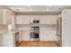 Bright kitchen featuring white cabinets, stainless steel appliances, and light countertops at 4411 Wild Honey Ct, Las Vegas, NV 89147