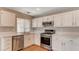 Bright kitchen featuring stainless steel appliances and white cabinets at 4411 Wild Honey Ct, Las Vegas, NV 89147
