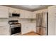 Bright kitchen featuring stainless steel appliances and white cabinets at 4411 Wild Honey Ct, Las Vegas, NV 89147