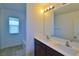 Bathroom featuring double sink vanity, framed mirror, and tiled shower/tub at 4905 Quiet Morning St, Las Vegas, NV 89122