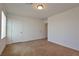 Neutral-carpeted bedroom with bright walls and multiple doorways at 4905 Quiet Morning St, Las Vegas, NV 89122