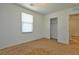 Bedroom features neutral tones, a window with blinds, carpeted floors and closet space at 4905 Quiet Morning St, Las Vegas, NV 89122