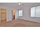 Bright bedroom featuring neutral carpet, closet, and an attached bathroom at 4905 Quiet Morning St, Las Vegas, NV 89122