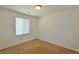 Carpeted bedroom with neutral walls and one window providing natural light at 4905 Quiet Morning St, Las Vegas, NV 89122