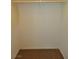 Walk-in closet with a wooden hanging rod and a neutral-colored carpeted floor at 4905 Quiet Morning St, Las Vegas, NV 89122