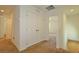 Upstairs hallway featuring neutral-colored carpet, closet, and doorways to other rooms at 4905 Quiet Morning St, Las Vegas, NV 89122