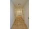 Long hallway featuring neutral tile, white doors, and access to various rooms at 4905 Quiet Morning St, Las Vegas, NV 89122