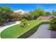 Lush artificial grass and mature landscaping create a private and inviting backyard oasis at 5521 Moss Landing St, North Las Vegas, NV 89031