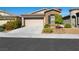 Charming single-story home featuring a two-car garage and nicely landscaped front yard at 5521 Moss Landing St, North Las Vegas, NV 89031