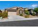 Well-maintained single-story home with neutral exterior, two-car garage, and manicured landscaping at 5521 Moss Landing St, North Las Vegas, NV 89031