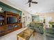 Inviting living room featuring neutral carpet, a large TV, and a seamless flow to the dining area at 5521 Moss Landing St, North Las Vegas, NV 89031