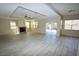 Bright living room featuring tile floors, a fireplace, and sliding glass doors to the backyard at 5808 Amber Station Ave, Las Vegas, NV 89131