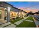 Gorgeous backyard with a covered patio, outdoor seating, lush landscaping and a walking path at 600 Quail Covey Road, Henderson, NV 89002