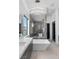 Bright and airy bathroom with a soaking tub, marble shower, and stylish lighting fixtures at 600 Quail Covey Road, Henderson, NV 89002