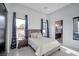 Bright bedroom featuring large windows, a comfortable bed, and stylish décor at 600 Quail Covey Road, Henderson, NV 89002