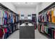 Spacious walk-in closet with custom shelving and storage provides ample space for clothes and accessories at 600 Quail Covey Road, Henderson, NV 89002