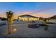 A well-lit modern home with minimalist landscaping against a vibrant sunset at 600 Quail Covey Road, Henderson, NV 89002