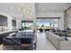 Open-concept living space with a sleek kitchen island and high-end appliances at 600 Quail Covey Road, Henderson, NV 89002