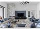 Spacious living room with a modern fireplace, comfortable seating, and a high ceiling at 600 Quail Covey Road, Henderson, NV 89002