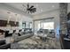 Open-concept living room showcasing modern decor, a large fan, and sliding doors to the patio at 600 Quail Covey Road, Henderson, NV 89002