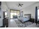 Serene main bedroom featuring a cozy bed, stylish dresser, and sliding glass doors to the patio at 600 Quail Covey Road, Henderson, NV 89002