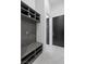 Well-organized mudroom with storage cubbies, a bench, and hooks for coats and bags at 600 Quail Covey Road, Henderson, NV 89002