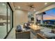 Covered patio with comfortable seating, a fire pit, and views of the landscaped backyard at 600 Quail Covey Road, Henderson, NV 89002