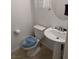 Powder room featuring tile floors, white fixtures and a pedestal sink at 7057 Millers Run St, North Las Vegas, NV 89084
