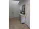 View of entryway featuring tile flooring, white door and a white sideboard table at 7057 Millers Run St, North Las Vegas, NV 89084