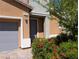 Close up of front door and landscaping, showing brick pavers, exterior lighting and a tidy garden at 7057 Millers Run St, North Las Vegas, NV 89084