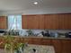 Spacious kitchen with granite countertops and light wood cabinets offering ample storage at 7057 Millers Run St, North Las Vegas, NV 89084