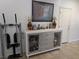 Living room featuring a grey sideboard with cabinets, a painting and an elliptical machine at 7057 Millers Run St, North Las Vegas, NV 89084