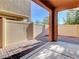 Covered patio featuring brick pavers, concrete area and a privacy fence at 7057 Millers Run St, North Las Vegas, NV 89084