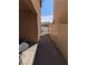 Side yard featuring brick pavers and white vinyl fencing to create a private outdoor space at 7057 Millers Run St, North Las Vegas, NV 89084