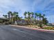 Neighborhood streetscape with mature palm trees, well-kept landscaping, with residential buildings in the background at 7115 S Durango Dr # 208, Las Vegas, NV 89113