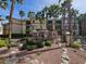 Well-maintained apartment complex featuring a decorative waterfall feature surrounded by lush greenery and mature trees at 7115 S Durango Dr # 208, Las Vegas, NV 89113