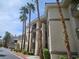 Apartment building with palm trees and balconies provides a comfortable and convenient living experience in a tropical setting at 7115 S Durango Dr # 208, Las Vegas, NV 89113