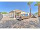 Backyard with vintage cars, a covered patio, and low-maintenance desert landscaping at 719 Roberta Alecia Ave, North Las Vegas, NV 89031