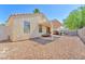 This backyard offers low-maintenance gravel landscaping and covered patio at 719 Roberta Alecia Ave, North Las Vegas, NV 89031