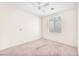A sunlit bedroom featuring a ceiling fan and carpeted floors at 719 Roberta Alecia Ave, North Las Vegas, NV 89031