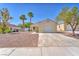 Charming single-story home with a two-car garage and low maintenance desert landscaping at 719 Roberta Alecia Ave, North Las Vegas, NV 89031