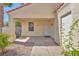 View of the cozy, covered front porch with shade, gravel landscaping, and neutral colored exterior at 719 Roberta Alecia Ave, North Las Vegas, NV 89031
