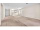 Open-concept living room with neutral carpet and a view into the kitchen area at 719 Roberta Alecia Ave, North Las Vegas, NV 89031