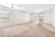 Spacious living room with carpeted floors, ceiling fan, and sliding glass door to the outside patio at 719 Roberta Alecia Ave, North Las Vegas, NV 89031