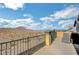 Balcony view of desert landscape, with metal railing, chaise lounge, and distant city view at 722 Chepstow Ave, Las Vegas, NV 89178